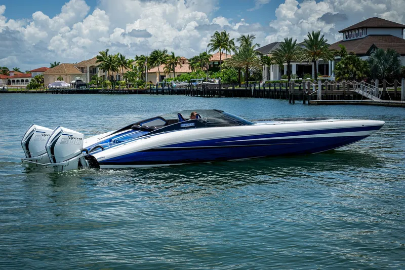 Slide: The Image of 2023 Performance Powerboats P360 on water, sleek design, dual engines, luxury waterfront homes in background. - 12