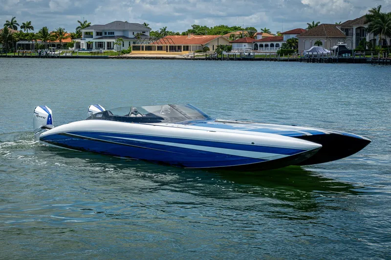 Slide: The Image of 2023 Performance Powerboats P360 on water, sleek design, luxury waterfront homes in background. - 14