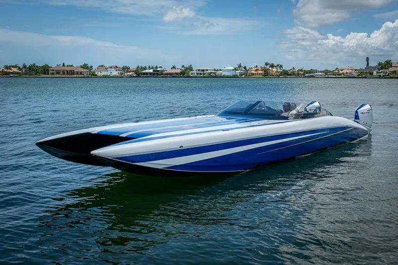 Slide: The Image of 2023 Performance Powerboats P360 on calm water, showcasing sleek design and vibrant blue accents. - 16