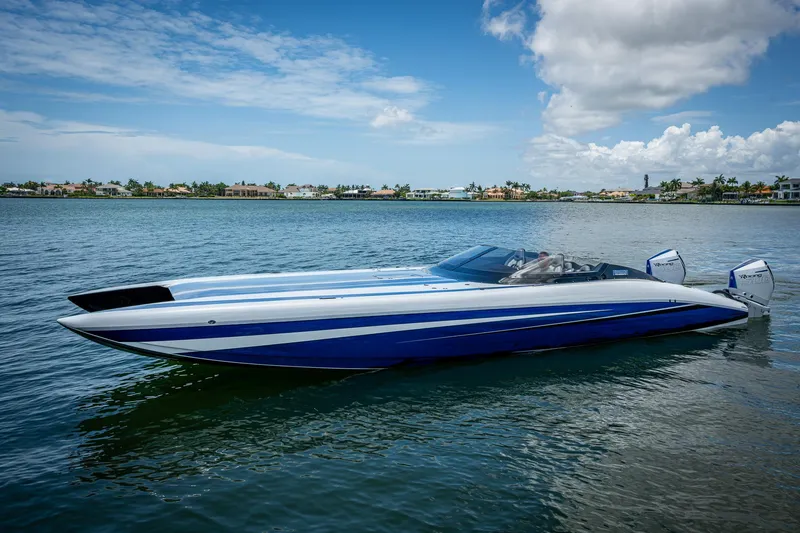 Slide: The Image of 2023 Performance Powerboats P360 on calm water, showcasing sleek design and vibrant blue accents. - 17