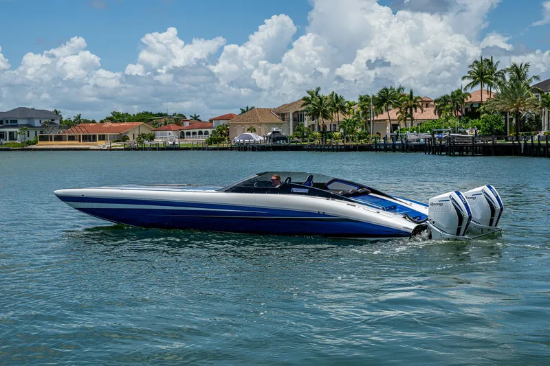 Slide: The Image of 2023 Performance Powerboats P360 on water, with luxury homes in the background. - 2