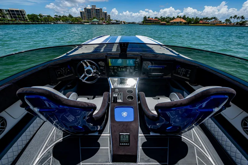 Slide: The Image of 2023 Performance Powerboats P360 cockpit with dual seats, advanced controls, and scenic water view. - 26