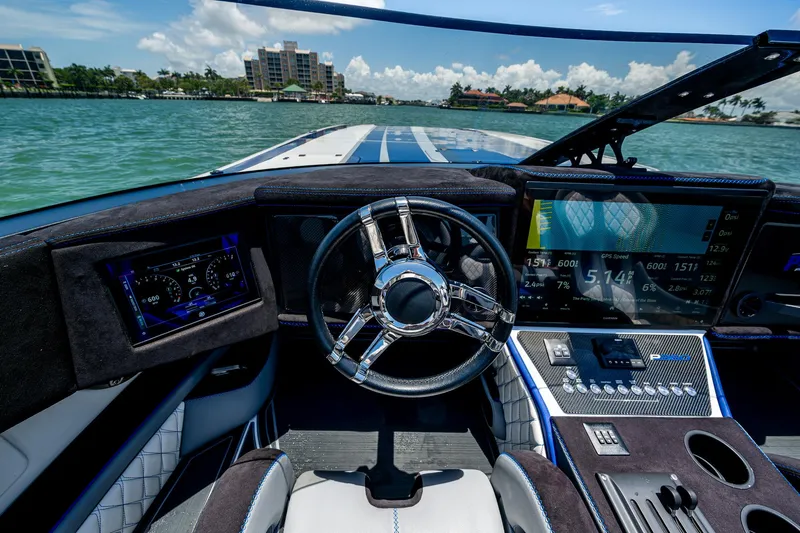 Slide: The Image of 2023 Performance Powerboats P360 cockpit with advanced navigation displays and sleek steering wheel. - 27