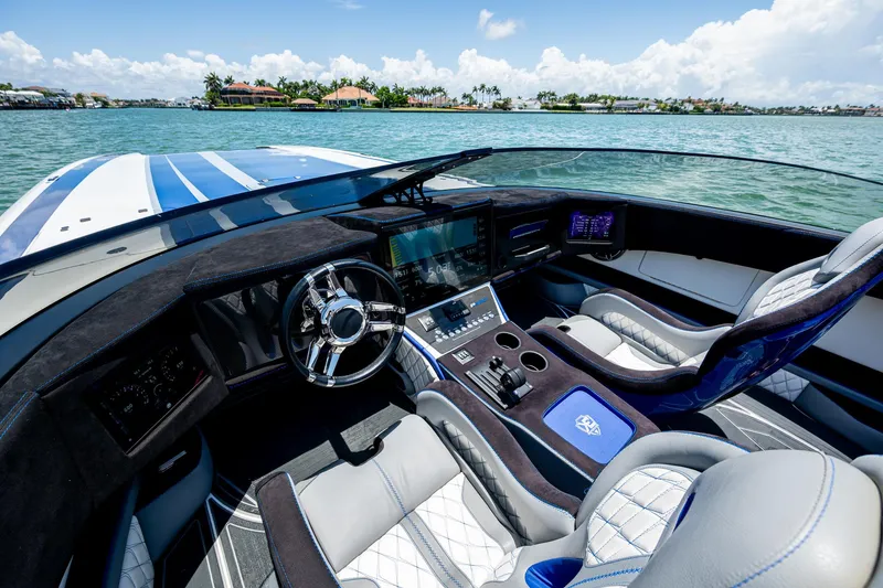 Slide: The Image of 2023 Performance Powerboats P360 cockpit with luxurious seating and advanced navigation system on the water. - 29