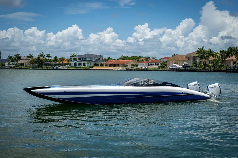 Slide: The Image of 2023 Performance Powerboats P360 on water, with luxury homes in the background. - 3