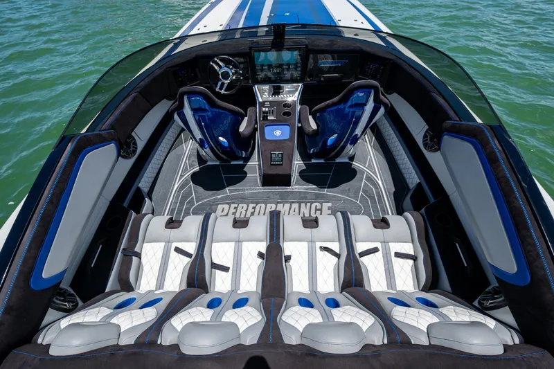 Slide: The Image of 2023 Performance Powerboats P360 interior with luxurious seating and modern dashboard on water. - 30