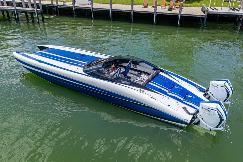 Slide: The Image of 2023 Performance Powerboats P360 in blue and white, docked on calm water. - 37
