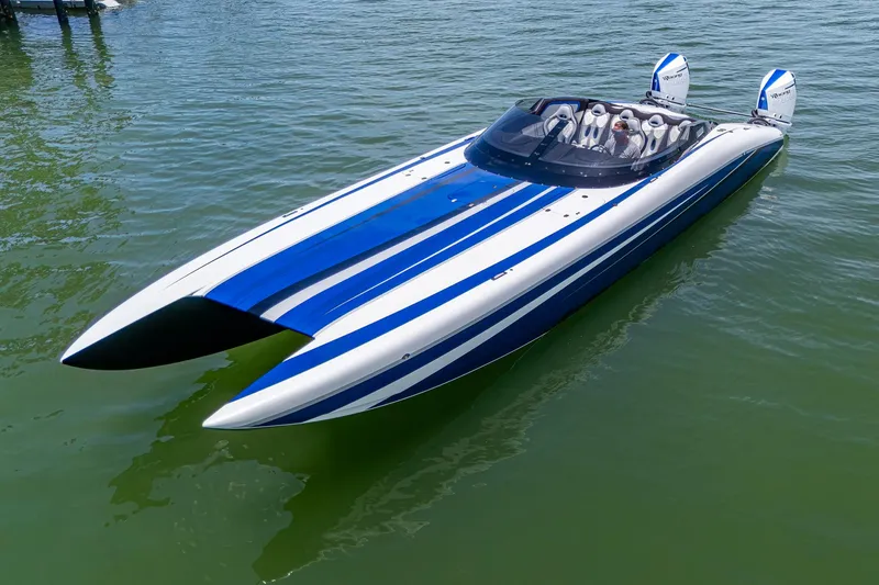 Slide: The Image of 2023 Performance Powerboats P360 with blue and white stripes on calm water. - 39