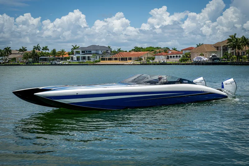 Slide: The Image of 2023 Performance Powerboats P360 on water, luxury waterfront homes in background. - 4