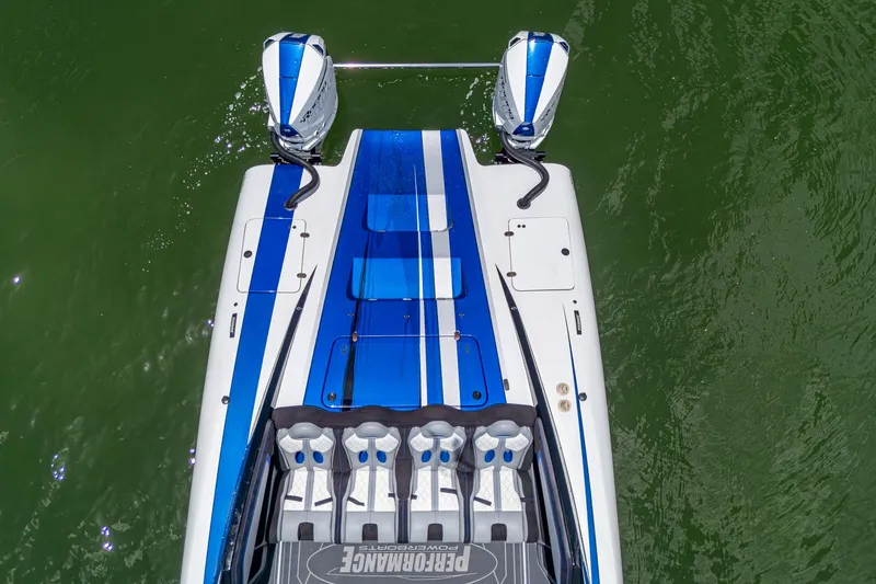 Slide: The Image of 2023 Performance Powerboats P360, aerial view, blue and white design, on green water. - 43