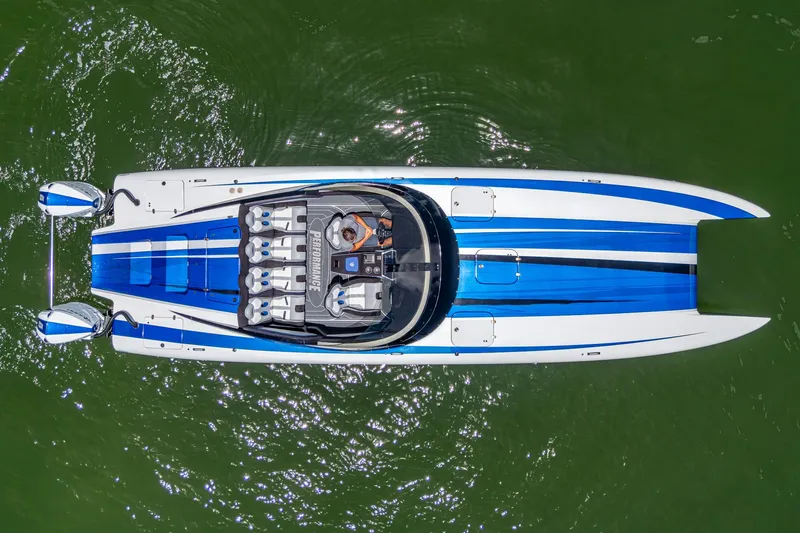 Slide: The Image of 2023 Performance Powerboats P360, aerial view, sleek design, blue and white, on green water. - 47