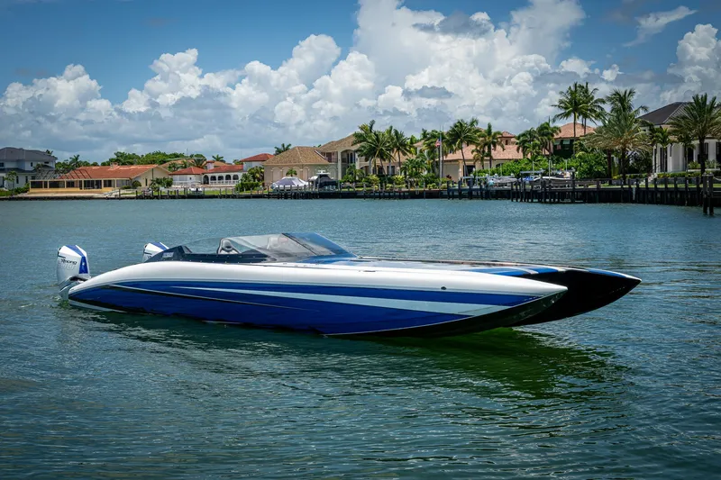 Slide: The Image of 2023 Performance Powerboats P360 on water, luxury waterfront homes in background. - 8
