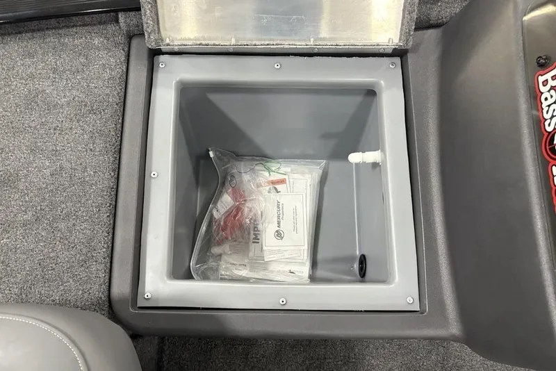 Slide: The Image of Storage compartment in 2025 Tracker BASS TRACKER® Classic XL boat, containing manuals and accessories. - 11
