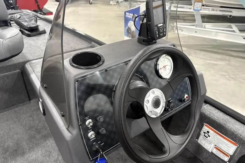 Slide: The Image of 2025 Tracker BASS TRACKER® Classic XL boat dashboard with steering wheel and gauges. - 12