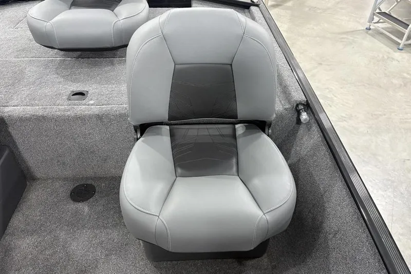 Slide: The Image of 2025 Tracker BASS TRACKER® Classic XL boat seat, gray upholstery, on carpeted deck. - 14