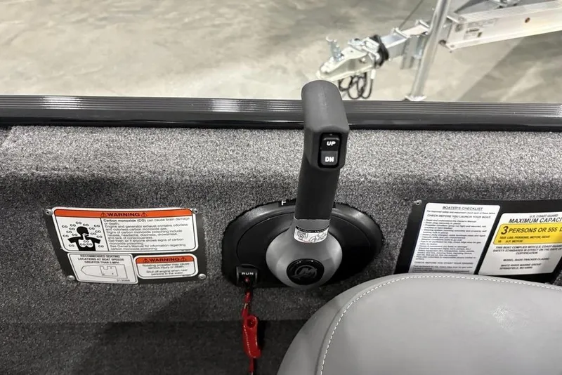Slide: The Image of 2025 Tracker BASS TRACKER® Classic XL boat control panel with warning labels and capacity information. - 17