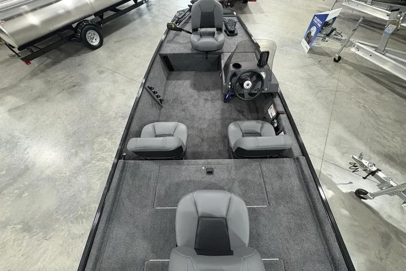 Slide: The Image of 2025 Tracker BASS TRACKER® Classic XL boat interior with gray seating and steering console. - 30