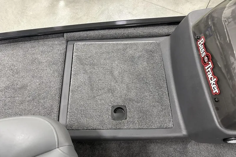 Slide: The Image of 2025 Tracker BASS TRACKER® Classic XL boat interior with carpeted deck and storage compartment. - 7