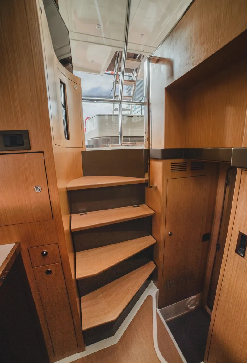 Slide: The Image of Interior staircase of 2011 Riva SportRiva 56 yacht, featuring wooden steps and modern design. - 18