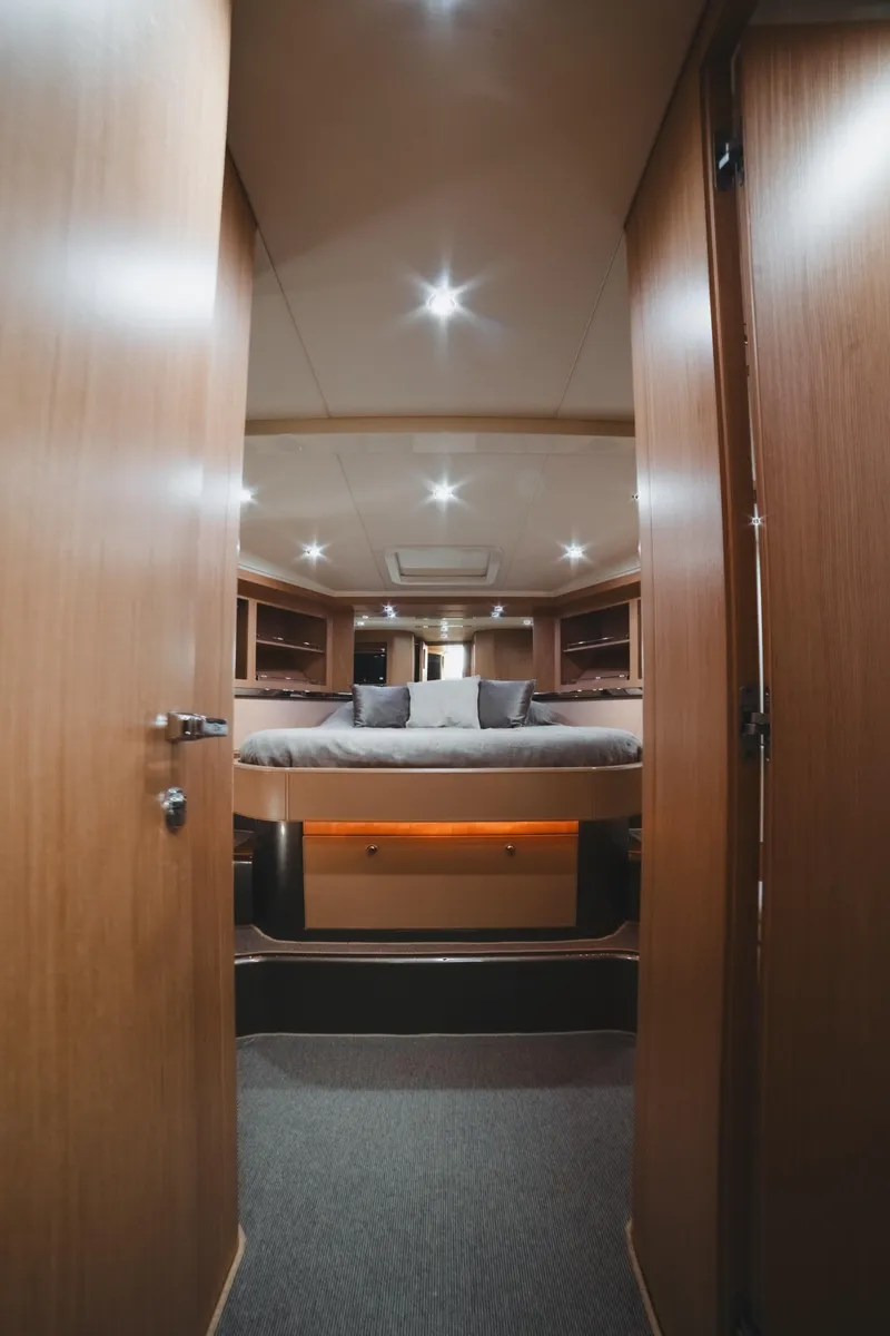 Slide: The Image of Luxurious interior of 2011 Riva SportRiva 56 yacht with elegant wood finish and cozy bedding. - 3