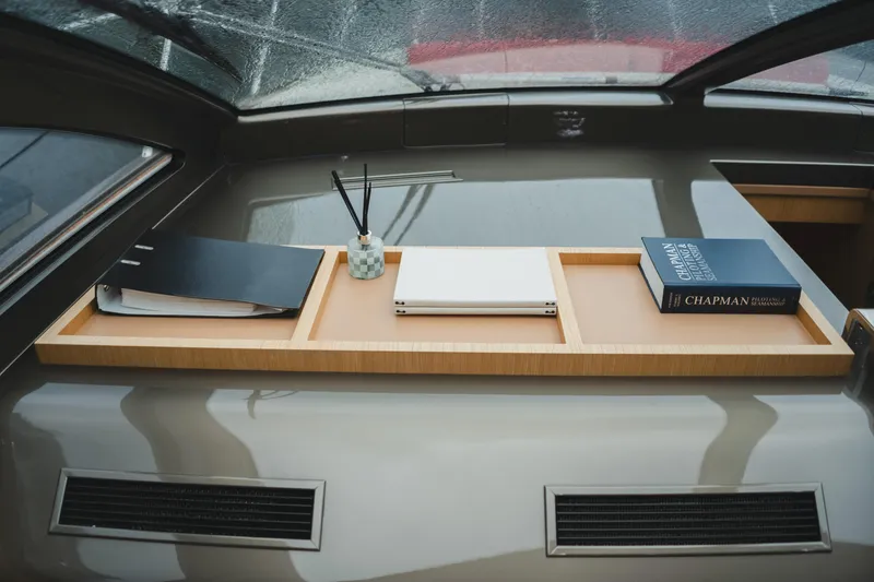 Slide: The Image of Interior of 2011 Riva SportRiva 56 yacht with books and decor on a wooden shelf. - 30