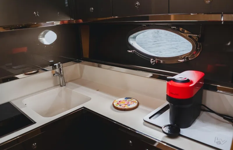 Slide: The Image of Luxurious 2011 Riva SportRiva 56 yacht kitchen with modern appliances and sleek design. - 33