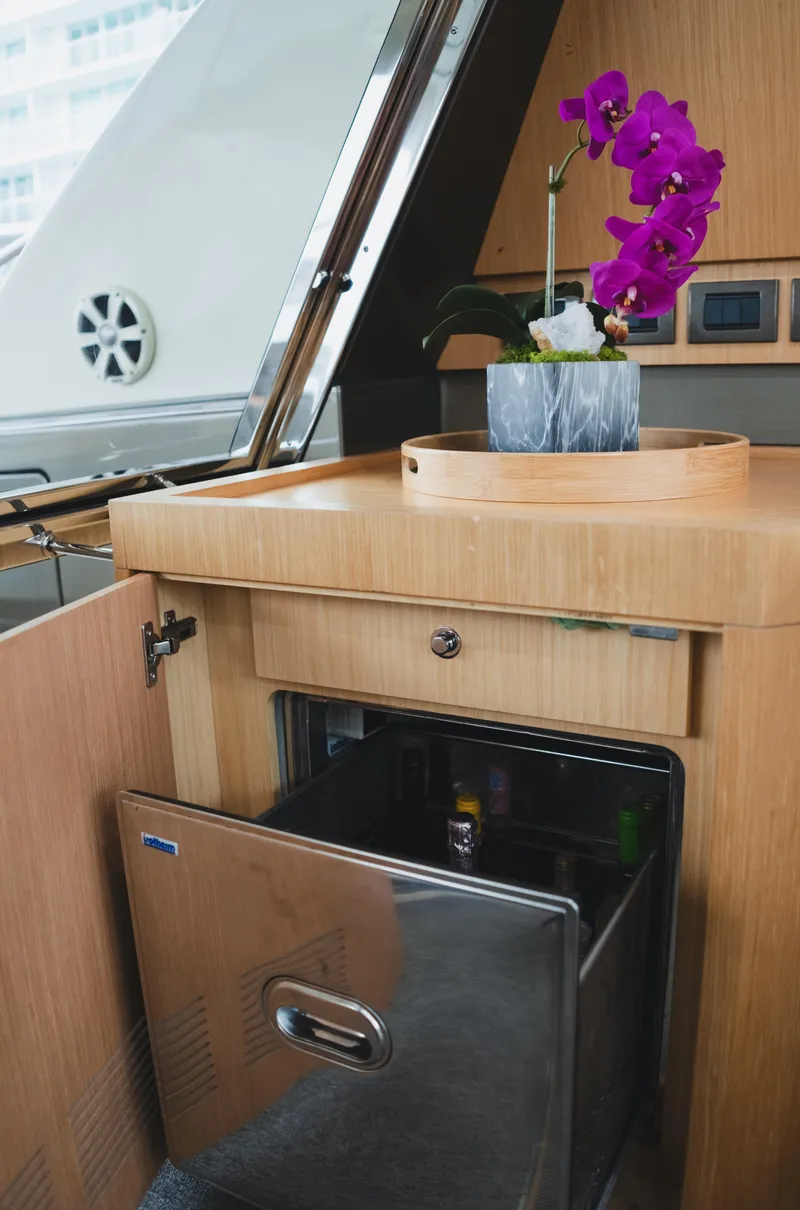 Slide: The Image of 2011 Riva SportRiva 56 yacht interior with open mini fridge and purple orchid. - 35