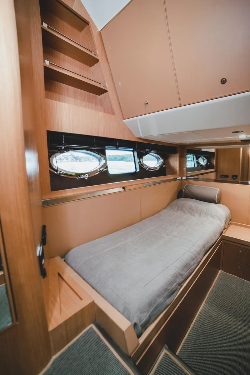 Slide: The Image of 2011 Riva SportRiva 56 yacht cabin with single bed and wooden interior. - 39