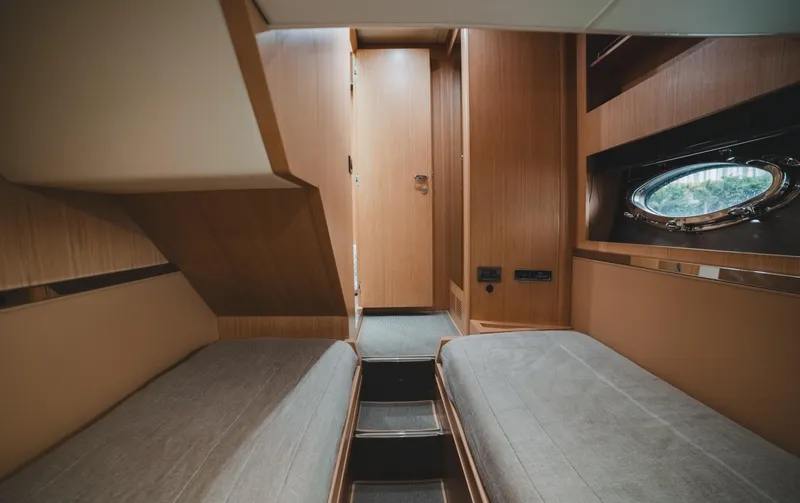 Slide: The Image of 2011 Riva SportRiva 56 yacht interior with twin beds and wooden finish. - 41