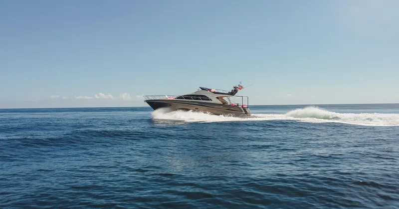 Slide: The Image of 2011 Riva SportRiva 56 yacht cruising on open sea under clear blue sky. - 5