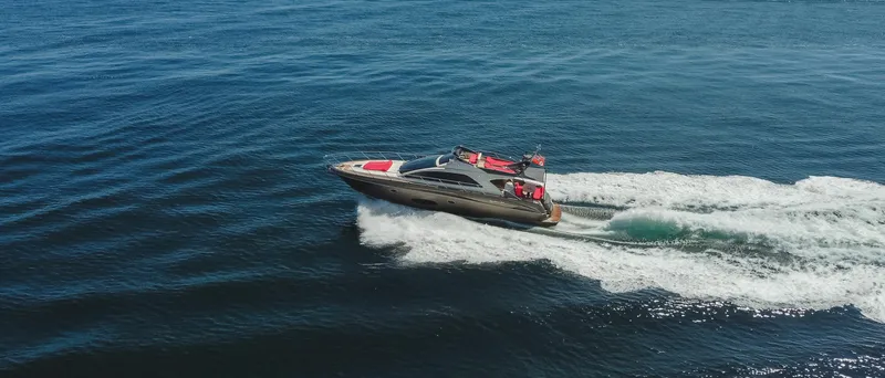 Slide: The Image of 2011 Riva SportRiva 56 yacht cruising on open water, creating a dynamic wake. - 6