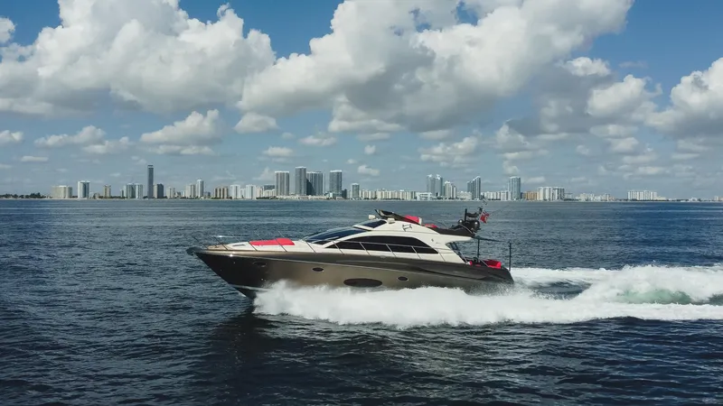 Slide: The Image of 2011 Riva SportRiva 56 yacht cruising on open water with city skyline in background. - 7