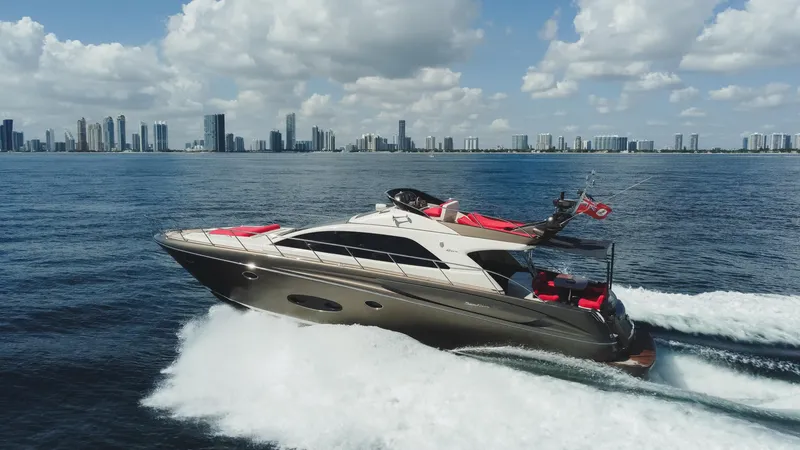 Slide: The Image of 2011 Riva SportRiva 56 yacht cruising on open water with city skyline backdrop. - 8