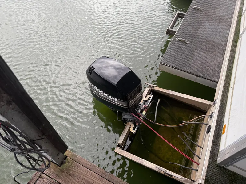 Slide: The Image of Outboard motor of a 2001 Myacht M Yacht docked on a lake. - 10
