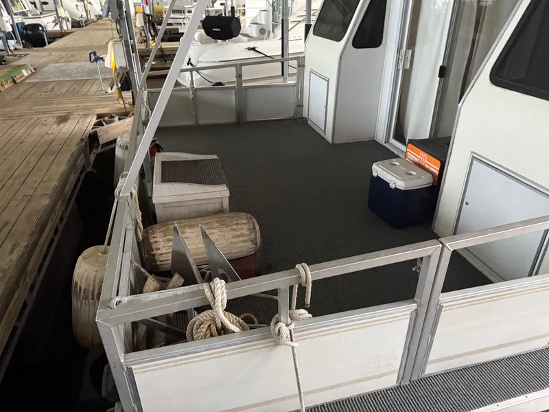 Slide: The Image of 2001 Myacht M Yacht deck with cooler, ropes, and docked at marina. - 11