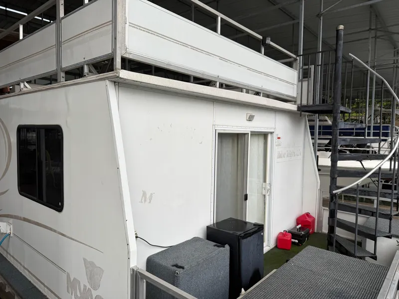 Slide: The Image of 2001 Myacht M Yacht with upper deck and spiral staircase in a covered dock. - 13