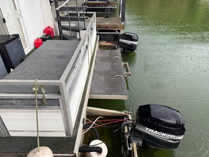 Slide: The Image of 2001 Myacht M Yacht docked with Tracker outboard motors on a calm lake. - 14