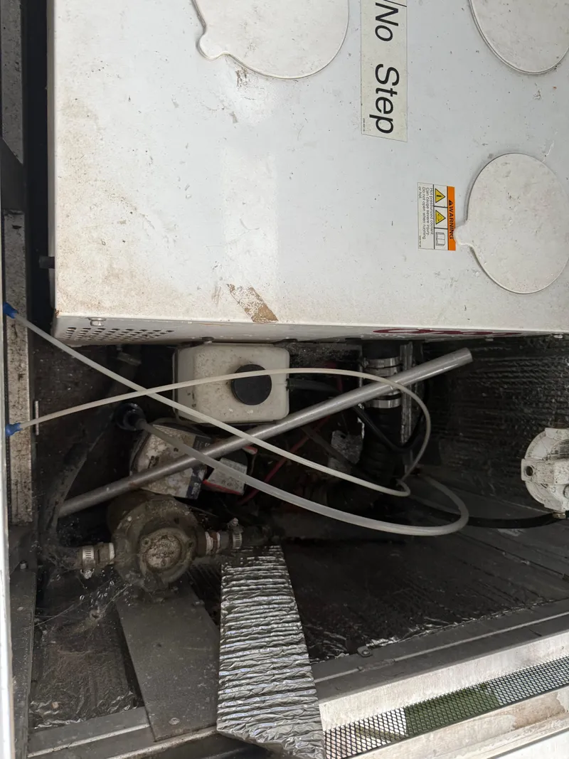 Slide: The Image of Engine compartment of a 2001 Myacht M Yacht with visible machinery and "No Step" warning. - 17