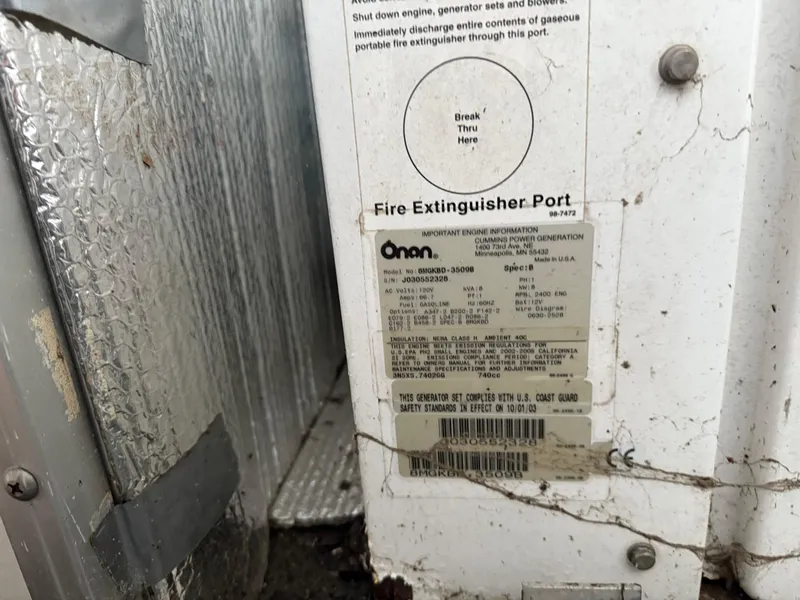 Slide: The Image of Fire extinguisher port on a 2001 Myacht M Yacht with Onan engine information label. - 19