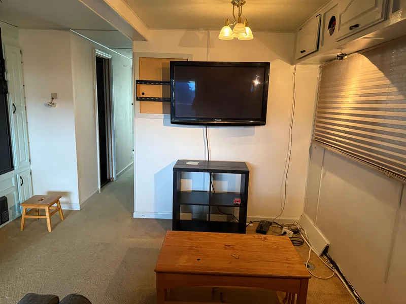 Slide: The Image of Interior of 2001 Myacht M Yacht with TV, shelves, and wooden furniture. - 23