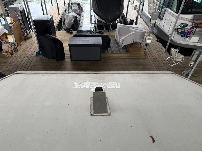 Slide: The Image of 2001 Myacht M Yacht docked with covered equipment and wooden deck. - 24