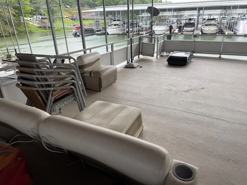 Slide: The Image of 2001 Myacht M Yacht deck with stacked chairs and seating, docked at marina. - 28