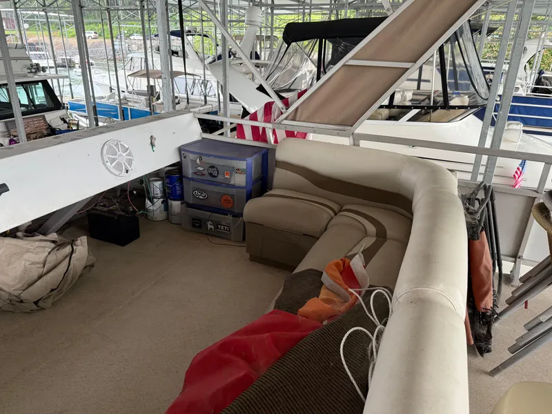 Slide: The Image of 2001 Myacht M Yacht interior with seating, cooler, and storage under a covered dock. - 33