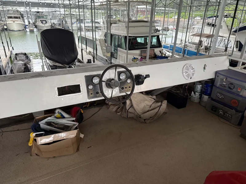 Slide: The Image of 2001 Myacht M Yacht helm with steering wheel and controls in a marina setting. - 34