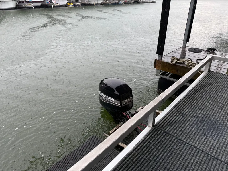 Slide: The Image of Outboard motor on a docked Myacht M Yacht, 2001 model, in rainy weather. - 36