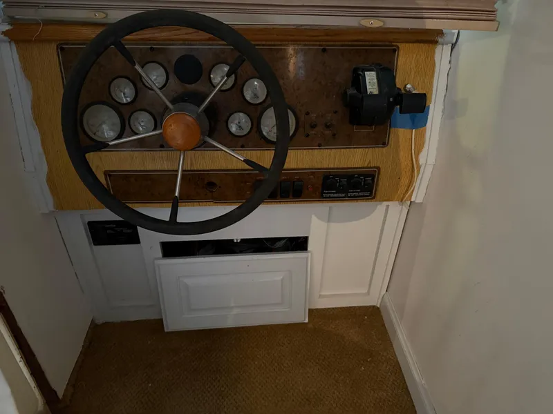 Slide: The Image of 2001 Myacht M Yacht steering wheel and control panel in a wooden dashboard. - 46