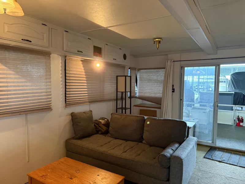 Slide: The Image of Interior of 2001 Myacht M Yacht with cozy sofa, wooden table, and large windows. - 49