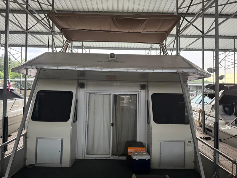 Slide: The Image of 2001 Myacht M Yacht docked under a covered marina, featuring sliding doors and shaded upper deck. - 5