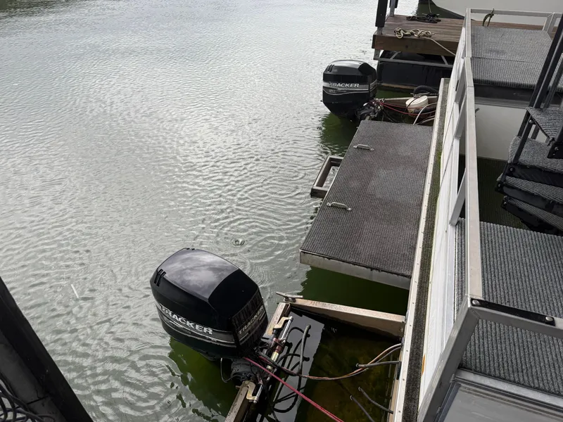 Slide: The Image of 2001 Myacht M Yacht with dual Tracker outboard motors docked on calm water. - 8