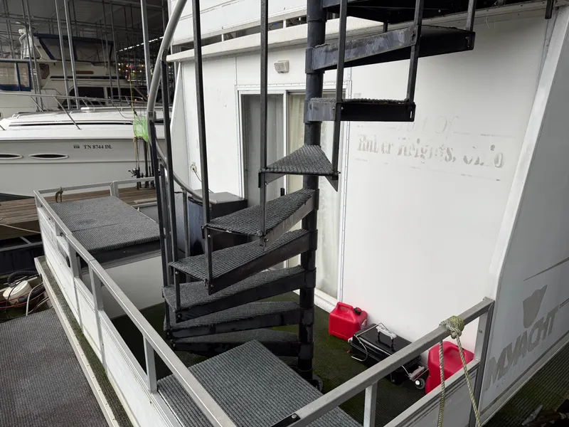 Slide: The Image of 2001 Myacht M Yacht with spiral staircase and docked boats in marina. - 9